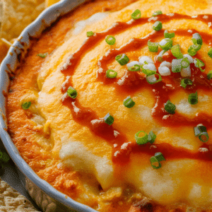 Turn up the heat with this crowd-pleasing Buffalo Chicken Dip! Loaded with shredded chicken, creamy cheeses, and spicy buffalo sauce, this dip is perfect for game days, parties, or any time you’re craving bold, zesty flavors. Serve it warm with chips, crackers, or veggie sticks for a guaranteed hit. 🌶️🐔🧀 Why You’ll Love This Dip Bold Flavors: Spicy buffalo sauce pairs perfectly with creamy cheeses and tender chicken. Quick & Easy: Ready in under 30 minutes with simple ingredients. Versatile: Perfect with chips, crackers, bread, or veggie sticks. Make Ahead: Easy to prep and bake when ready to serve. What Makes This Dip Special? Buffalo Chicken Dip takes all the flavors of your favorite wings and transforms them into a creamy, cheesy dip that’s perfect for sharing. It’s the ultimate appetizer for those who love heat and tangy goodness. Health Benefits: Chicken: A lean source of protein. Buffalo Sauce: Adds bold flavor without the need for excessive seasoning. Cheese: Provides calcium and richness. Fun Additions & Variations Extra Heat: Add a pinch of cayenne or drizzle with extra hot sauce. Ranch Lovers: Mix in a packet of ranch seasoning for added flavor. Blue Cheese Kick: Add crumbled blue cheese for a classic buffalo twist.