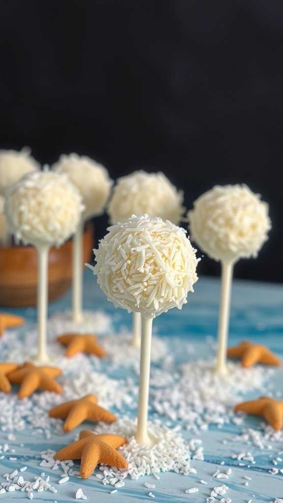 Coconut cream cake pops decorated with shredded coconut and surrounded by starfish candies on a blue surface.