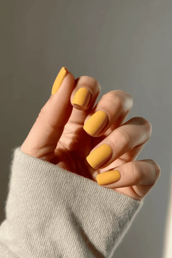 Matte mustard yellow short square nails.
