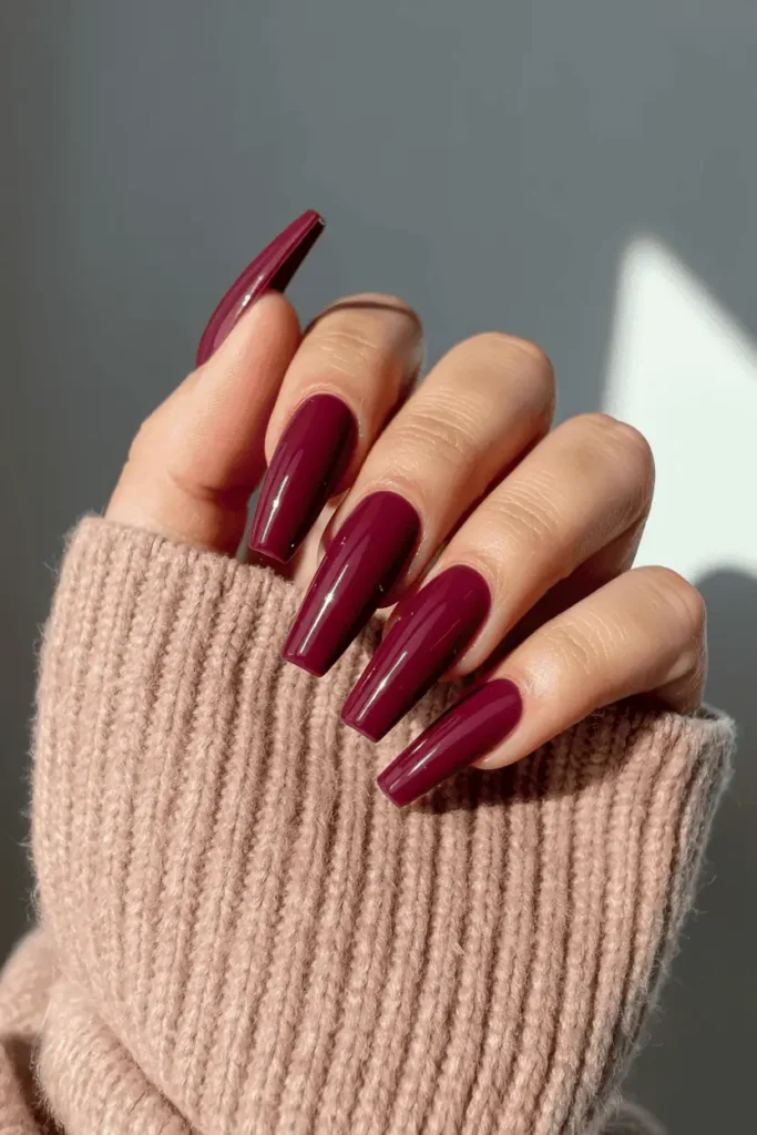 Glossy plum coffin nails styled with cozy scarf.