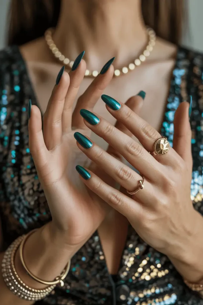 Deep metallic green nails catching the light, styled with gold jewelry and sequined outfit. Glam party background.